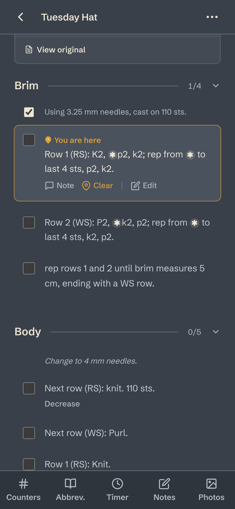 A pattern in the app: the Brim section as rows with tick boxes, the cast-on row ticked and You are here on Row 1.